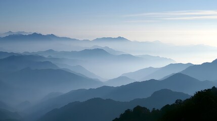 Naklejka premium Misty mountains are bathed in diffused morning light creating a serene and atmospheric landscape view