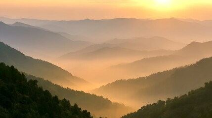 Obraz premium Majestic mountain ranges are enveloped in soft morning mist illuminated by warm golden hour light