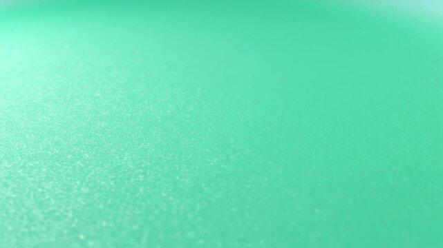 A smooth gradient background with soft light and mint green tones