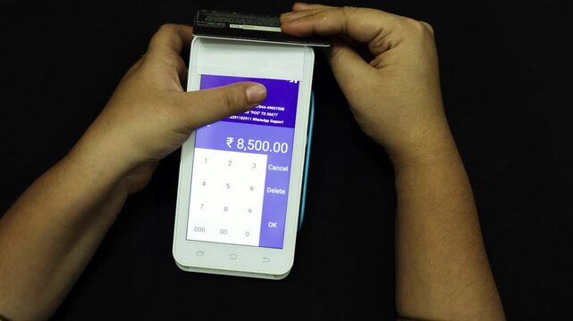 close up of customer making card payment on electronic pos machine with digital transaction concept