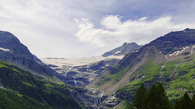 Beautiful Panoramic View over Alp Gr&uuml;m with Glacier and Mountain View in the Swiss alps in a Sunny Summer Day with Sky and Clouds in Poschiavo, Bernina, Grisons, Switzerland.