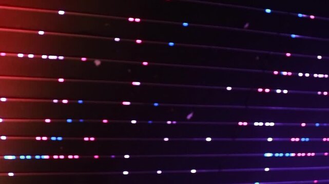 A vibrant display of colorful lights against a dark background with horizontal lines and a mix of red, blue, and white hues