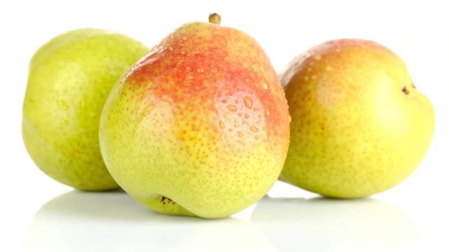 Three ripe pears with water droplets studio shot on white background fresh fruit