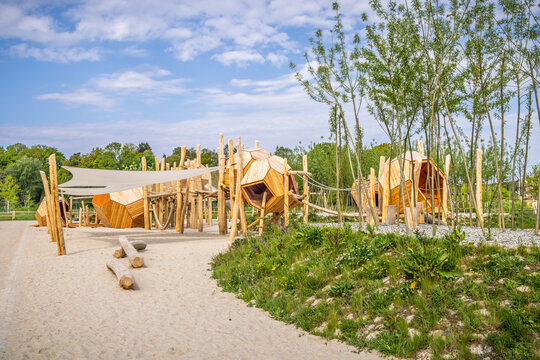 Empty modern wooden playground and climbing tower for kids in a public park