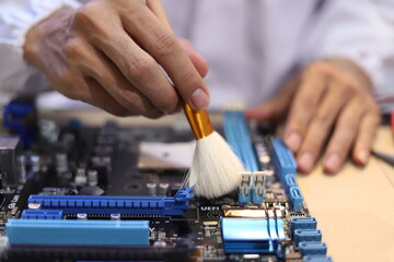 Obraz premium technician wearing white gloves fix circuit board using a magnifying glass tool during professional electronic hardware repair on a fully equipped modern technology workstation desk.