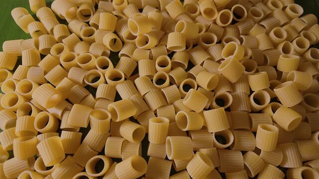 50p top view macro slider shot above uncooked mezze maniche pasta.