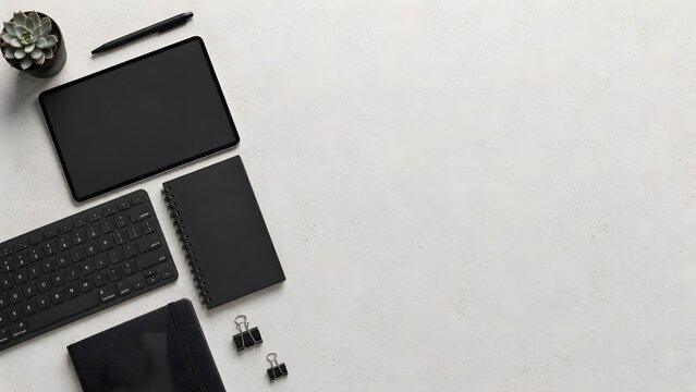 Modern Minimalist Black Workspace Stationery Flat Lay Featuring Tablet Mockup Wireless Keyboard Spiral Notebook and Succulent Plant on Light Textured Concrete Background.