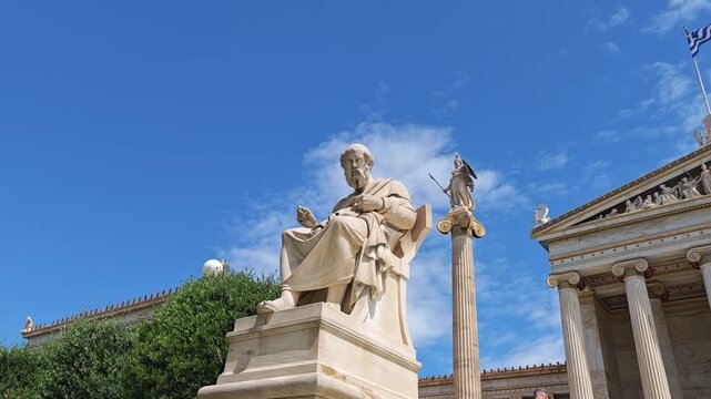 Horizontal tilt showing the Academy of Athens' neoclassical facade, the philosopher Plato's statue, and the Greek flag. Perfect for educational and cultural content.