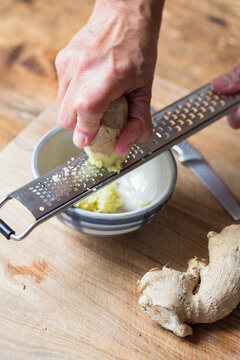 Woman grating ginger