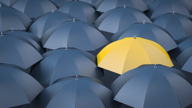 Yellow umbrella in between many black umbrellas