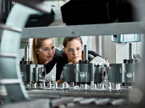 Young women checking production line on a conveyor belt