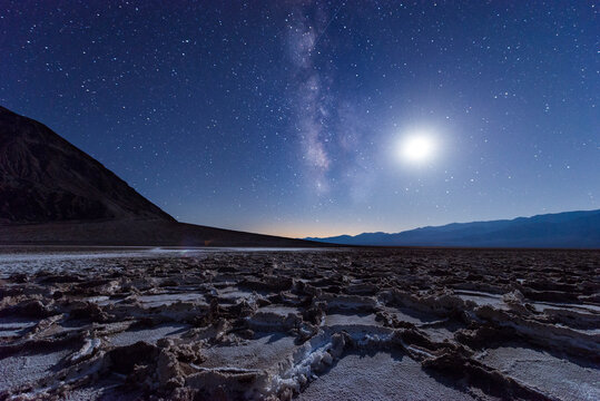 USA, California, Death Valley, Milky way and the moon over Badwater Basin