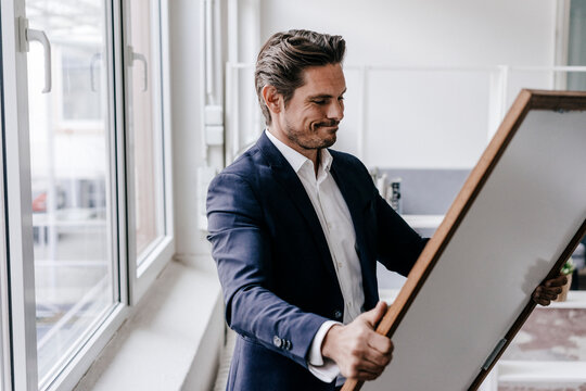 Businessman holding picture frame
