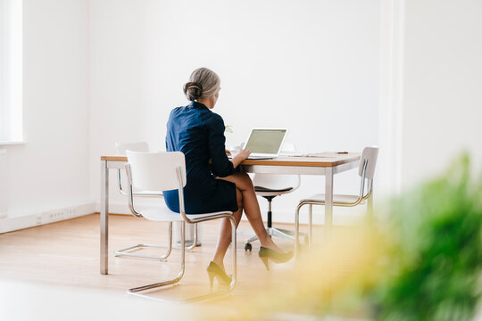 Businesswoman working on laptop in office