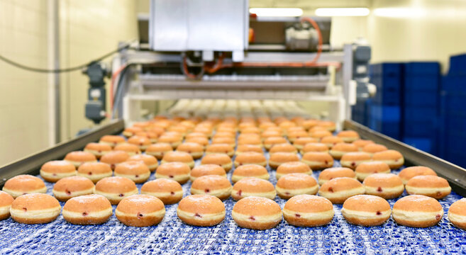Production line in a baking factory with Berliners