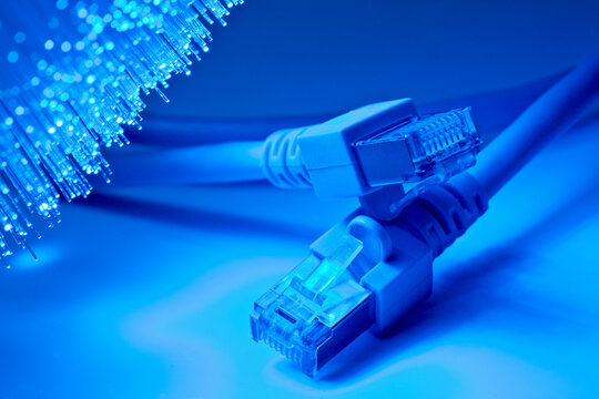 USB cable in front of blue fiber lights, close up