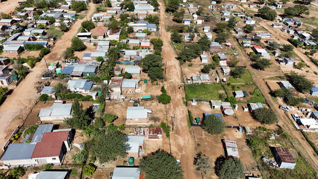 Aerial view of the residential settlement with small houses, dirt roads and scattered trees in Vaalwater, Limpopo, South Africa.