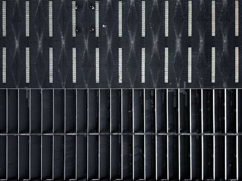 Aerial view of a large industrial roof with geometric patterns and skylights in Warsaw, Masovian Voivodeship, Poland.