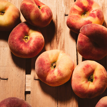 Ripe fig peaches on a wooden background