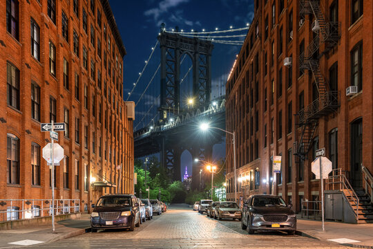 Manhattan Bridge at the end of Washington street Illuminated at night, DUMBO  neighbourhood, Brooklyn, New York, USA