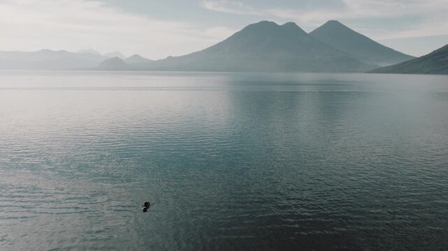 Cinematic Aerial of Fisherman Rowing Across Lake Atitlan