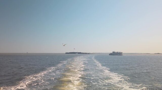 Gimbal wide shot from a moving boat looking back at Fort Sumter in Charleston Harbor, South Carolina. 4K at 60 FPS Slow Motion