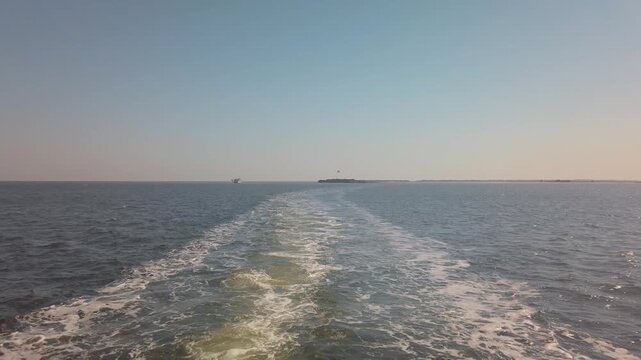 Gimbal wide shot from a moving ferry boat leaving Fort Sumter in Charleston Harbor, South Carolina. 4K