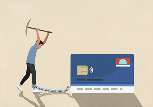 Man with axe attempting to break chain connecting ankle to credit card