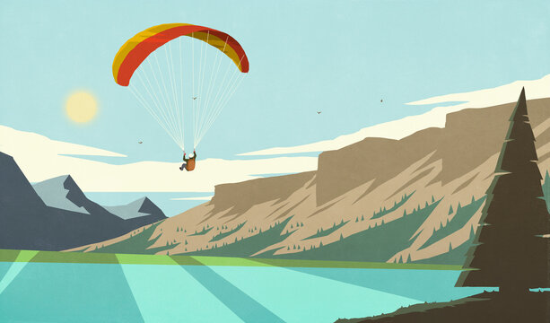 Parachuter flying over beautiful, idyllic summer mountain lake