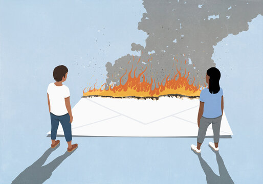 Couple looking down at burning envelope on blue background