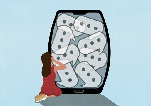Overwhelmed girl kneeling with head in hands next to text message speech bubbles on device screen