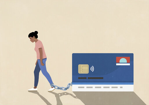 Dejected woman dragging large credit card chained to ankle on beige background