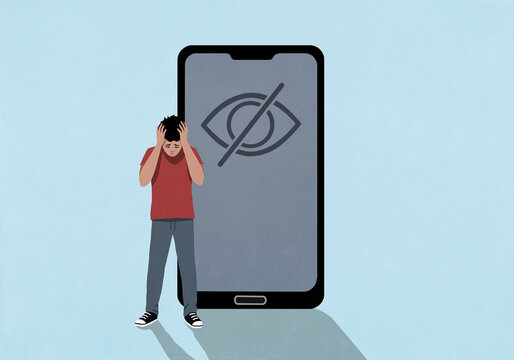 Frustrated teenage boy with head in hands next to privacy control symbol on smart phone screen
