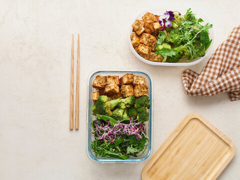 Still life view from above of fresh, healthy tofu salad with steamed broccoli in glass container