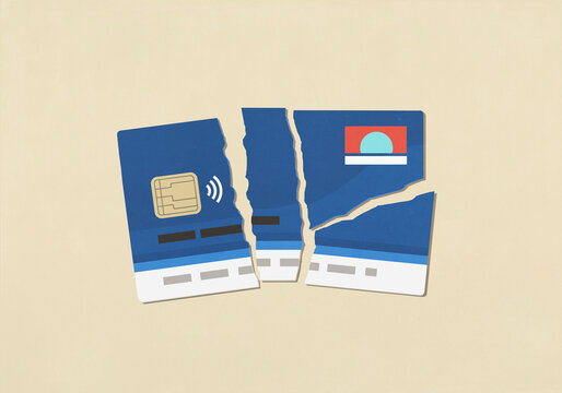 Cut credit card on beige background