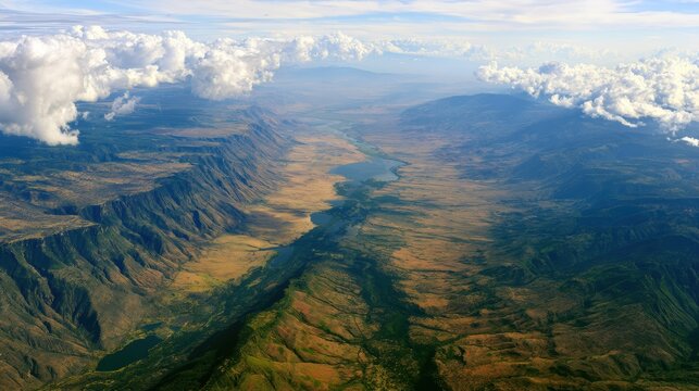 Aerial view of dramatic mountain valley with river and clouds geography landscape africa