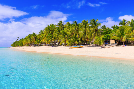 Dravuni Island, Fiji. Beach, boat and palm trees in the South Pacific ocean.