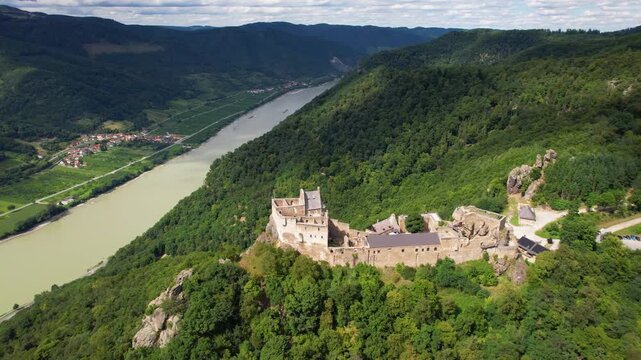Aggstein Castle Ruins Aerial Drone View Wachau Valley Danube River Cinematic Flight Imposing Hilltop Fortress Austria Landscape Green Hills Mountain Panorama Travel Destination UNESCO Historic View