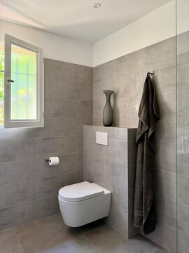 View through on open door into a stylish modern bathroom decorated in tones of grey