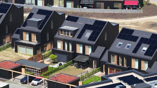 Modern residential neighborhood with solar panels and green roofs
