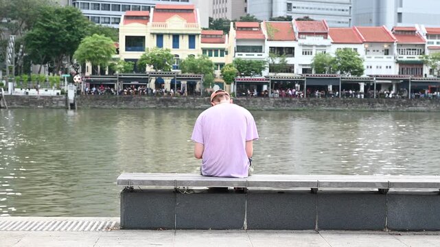 Man Sketching and Drawing on Notebook at Clarke Quay Riverside, Singapore