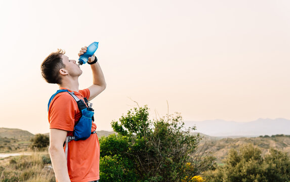 Man hydrating during trail running outdoor activity