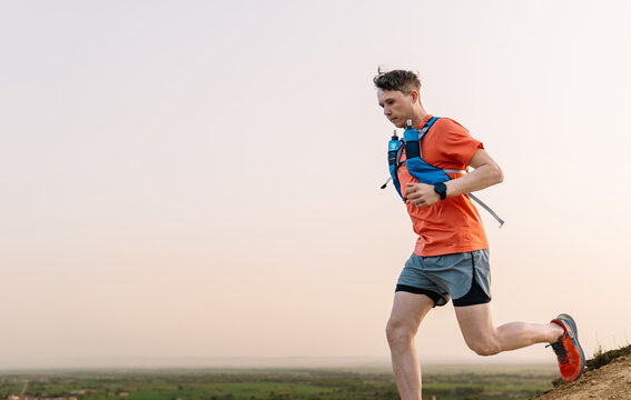Male trail runner exercising outdoors in nature