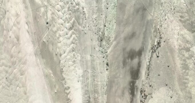 Aerial view of the textured dry riverbed with intricate sand ripple patterns and arid terrain in Kurigram, Rangpur Division, Bangladesh.