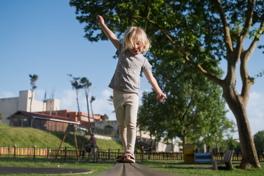 Active kid practicing balance and coordination on a sunny day.