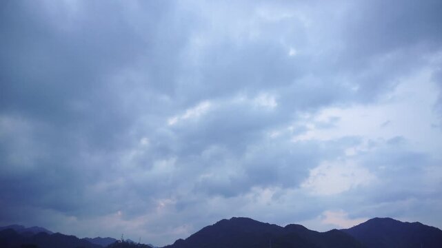Dramatic cloudy evening sky over mountain silhouettes