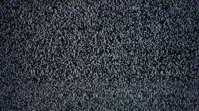 Analog television screen displaying black and white static noise texture in a seamless loop. The visual concept represents lost signal, broadcast interruption, and retro technology.