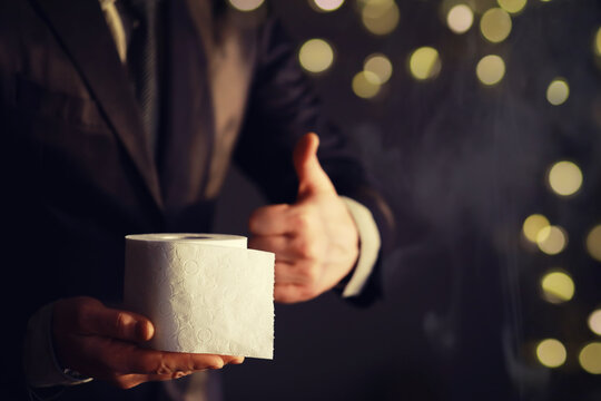 Businessman Holding a pile of Toilet Paper, copy space. Toilet papers is the new currency concept.