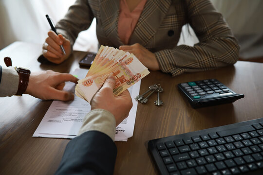 Businessman giving money, Russian Ruble currency, to hs partner - payment, loan and bribery concept