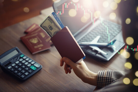 A man buys plane tickets from an agency. The client receives a passport with plane tickets from the travel agent.